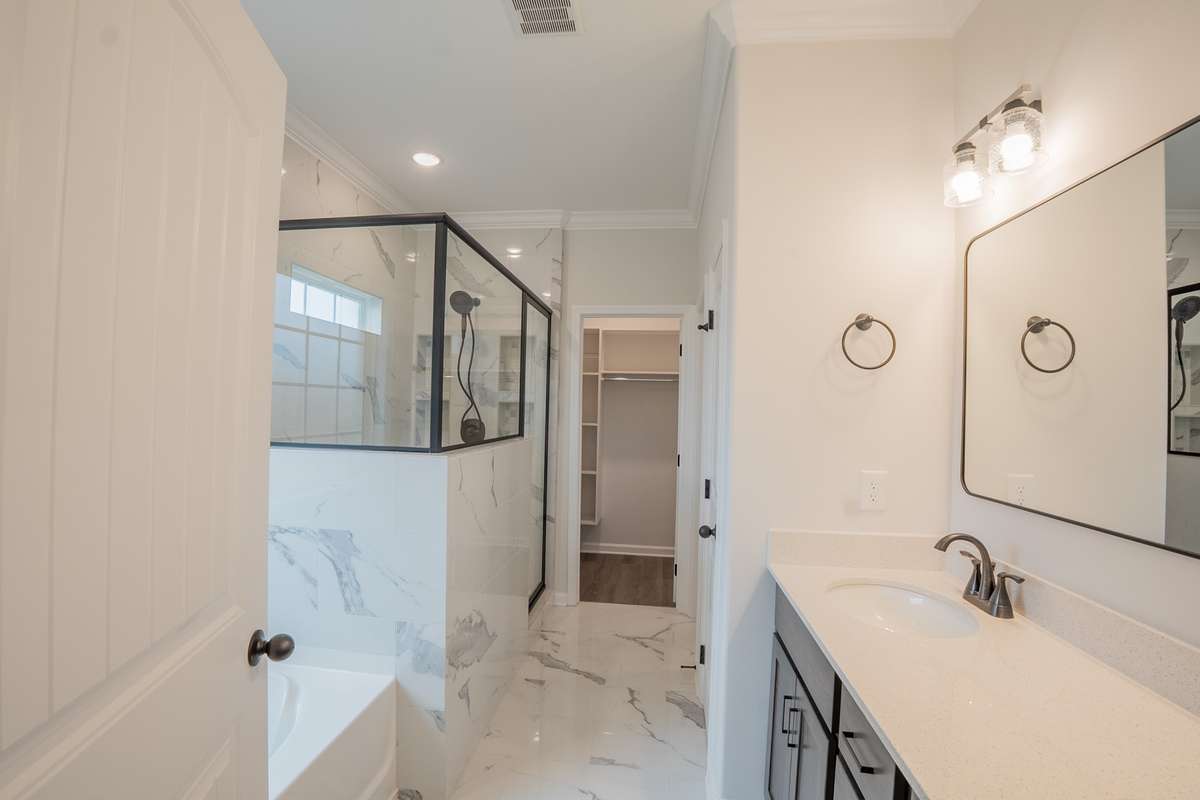 Primary Bathroom Features Recessed Lighting, Crown Molding, Soaker Tub, Tile Shower, a Double Vanity, Large Walk-in Closet and a Toilet Room!