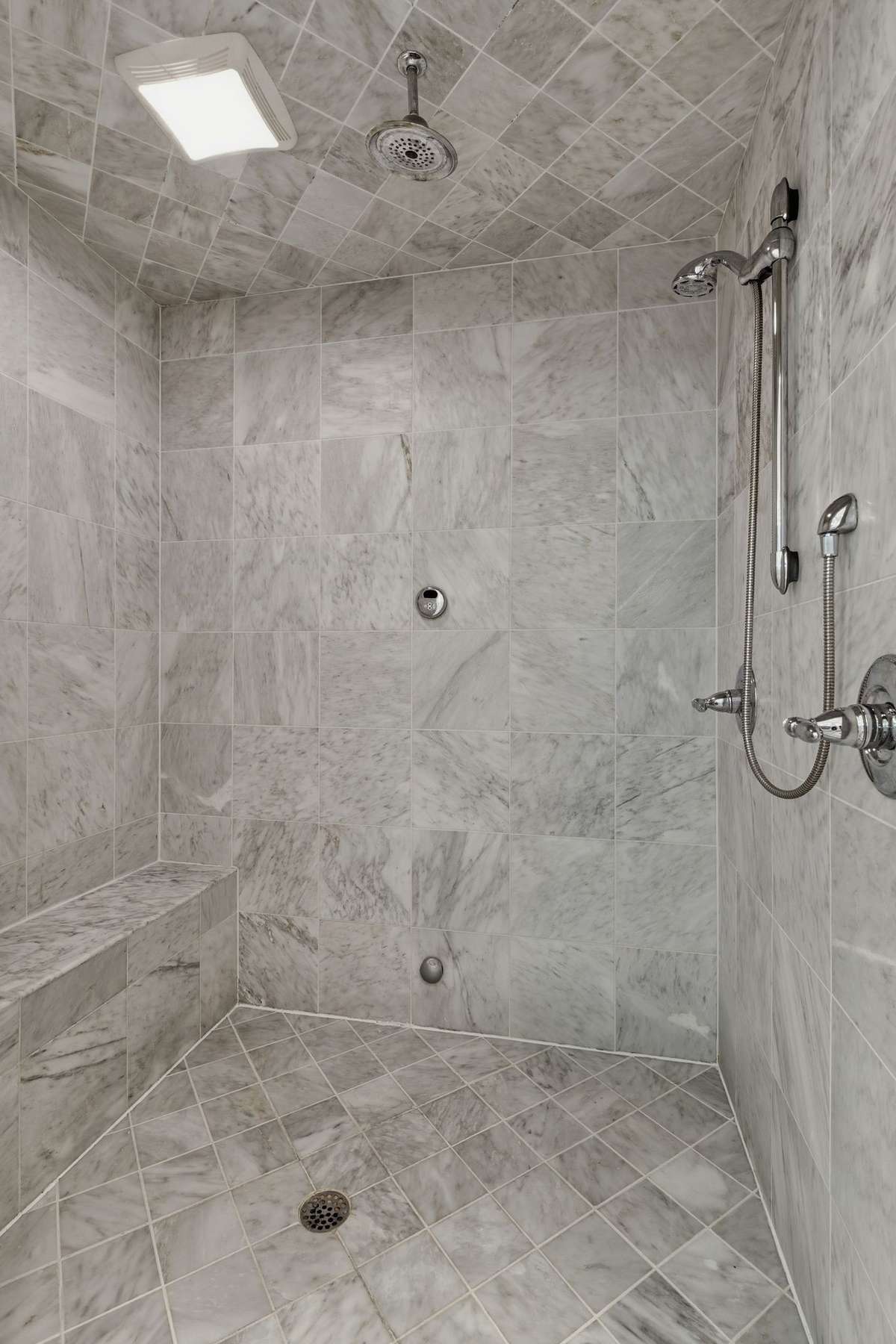 Primary shower with extra sprays, rain, head, and plenty of space to sit down and relax