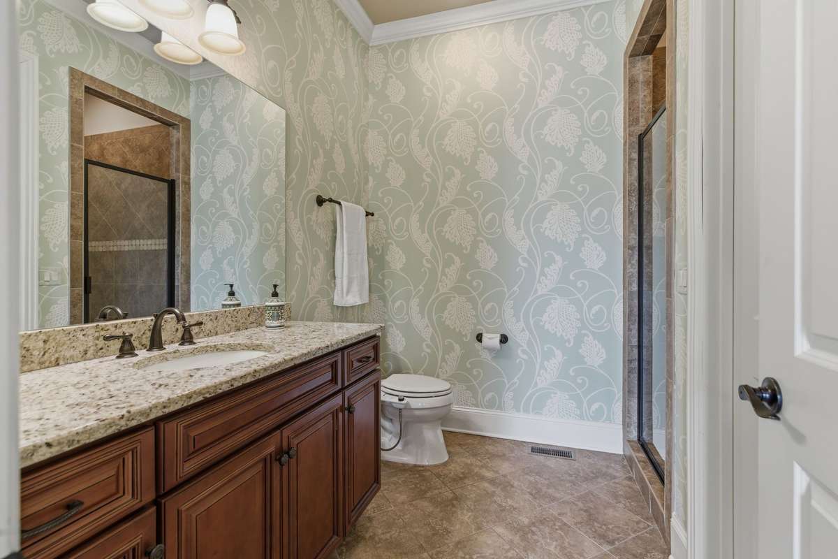 Bathroom to guest room downstairs has a walk-in closet and walk-in shower for easy access.