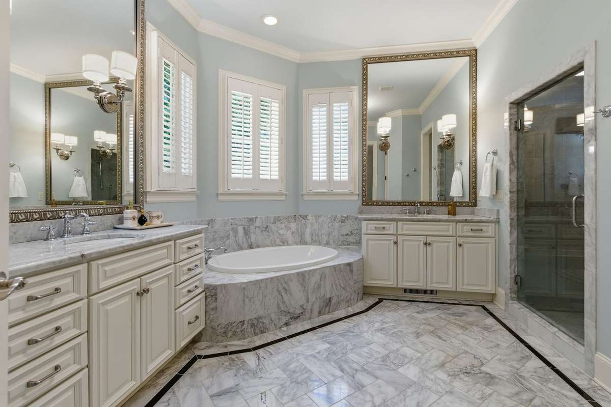 Double vanity, separate shower, and tub and plantation shutters. Make sure not to miss out on touring the closets.
