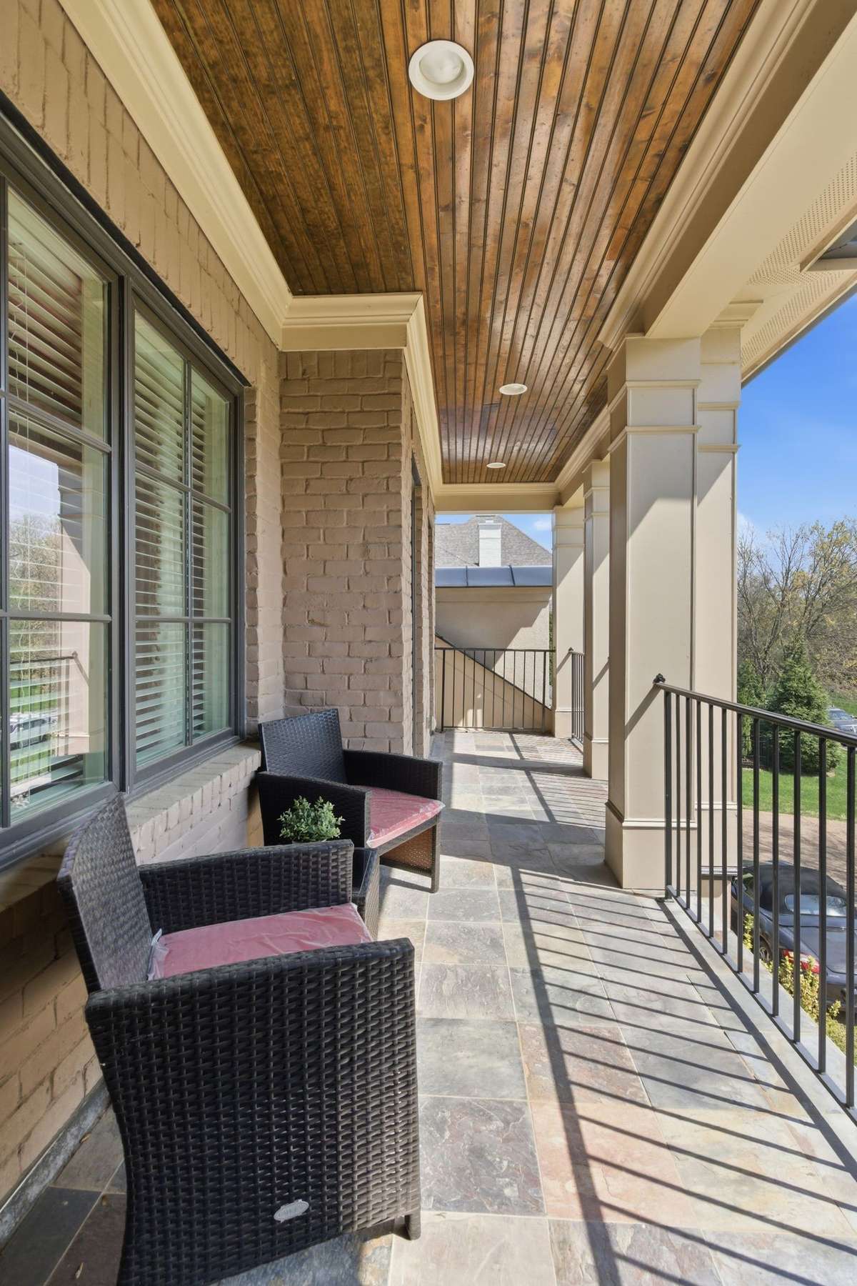 Shared balcony the overlook the wooded lot across the street.