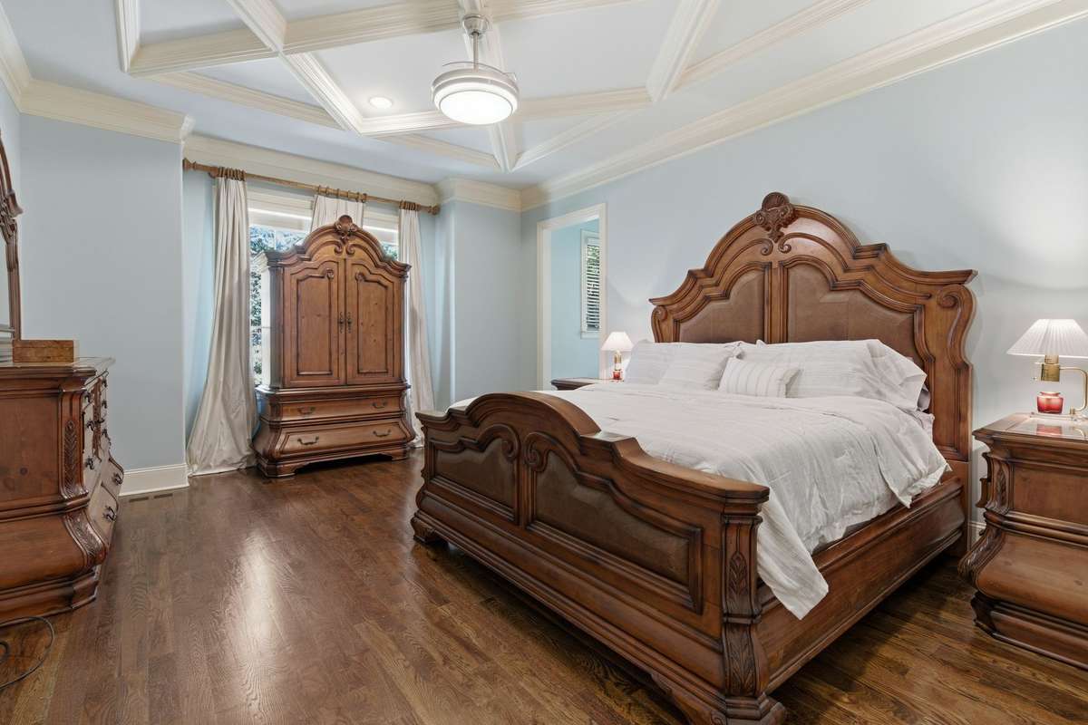 Primary bedroom is on the main floor in a tucked away spot.  It features Crawford ceiling and beautiful wood work. Is leads to the stunning bathroom suite.