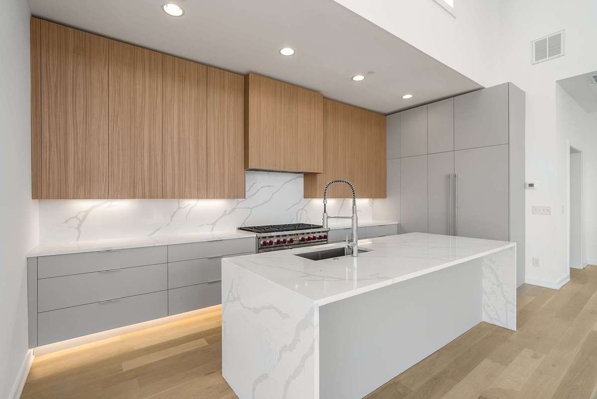 Bright and light chrome, wood, platinum color combination with quartz island and backsplash
