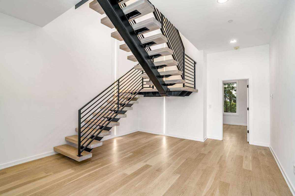 Foyer / Lobby with floating stairs and LED lighting up. 5th Bedroom or 2nd office beyond.