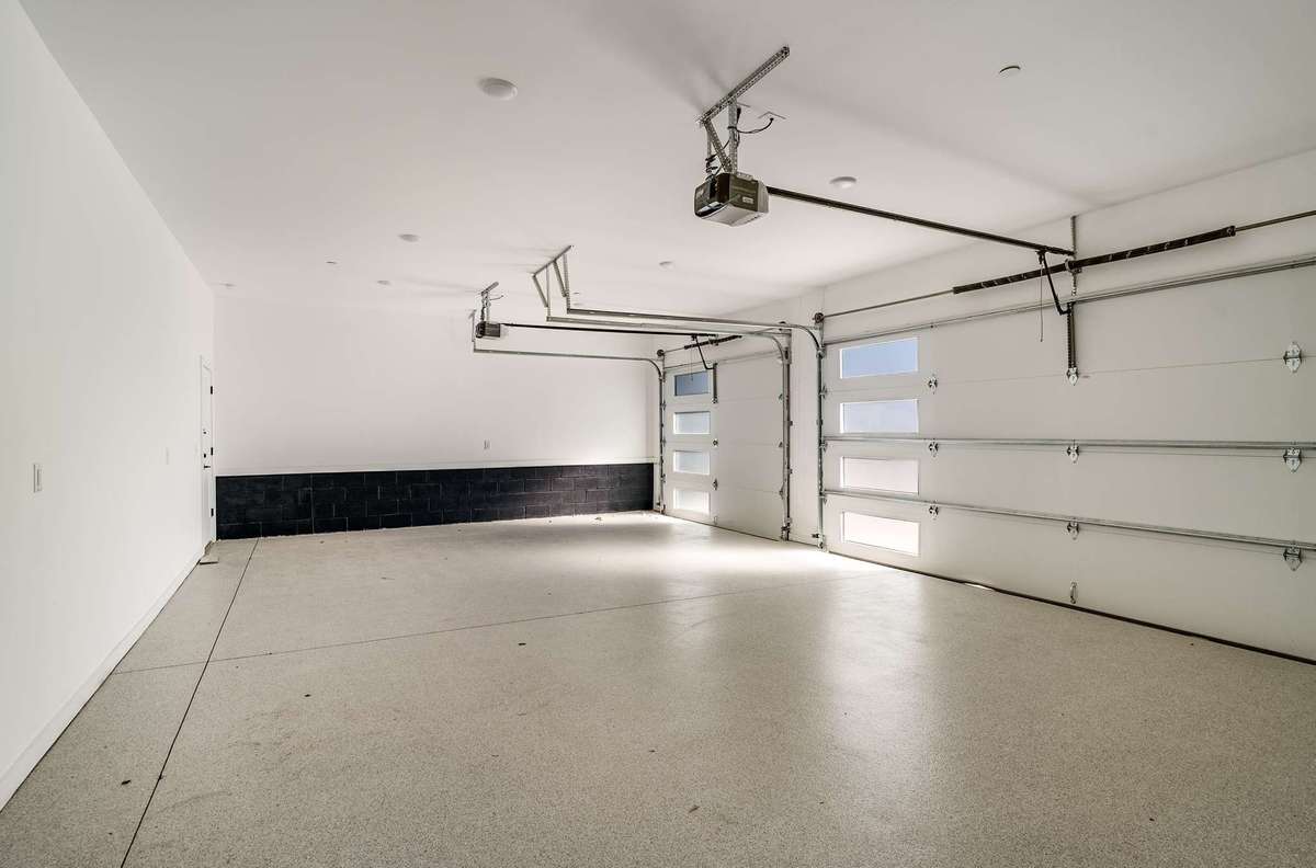 3 car garage with epoxy floor and there is also an additional storage room