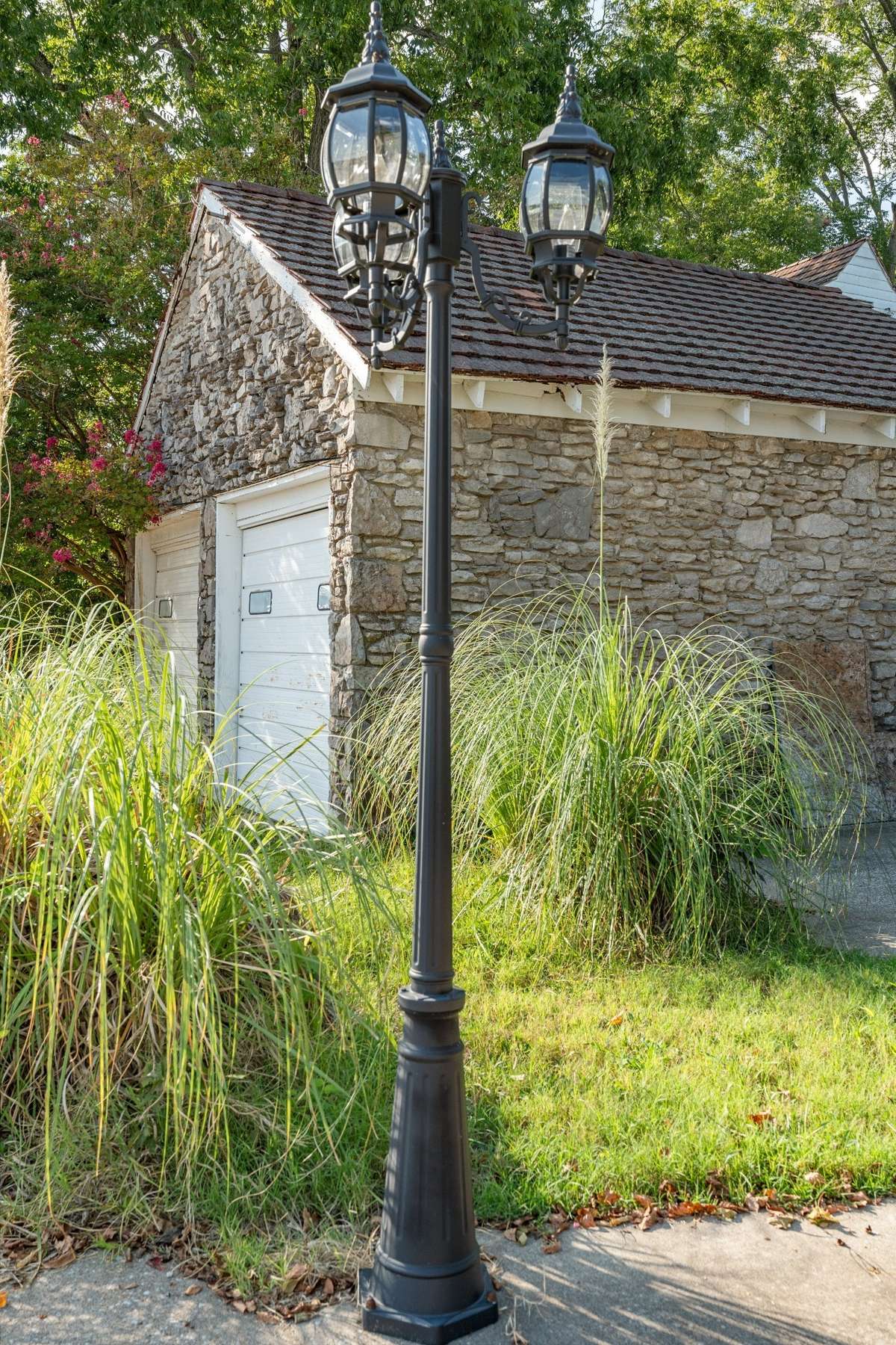Charming lamposts on both sides of the driveway entrance.