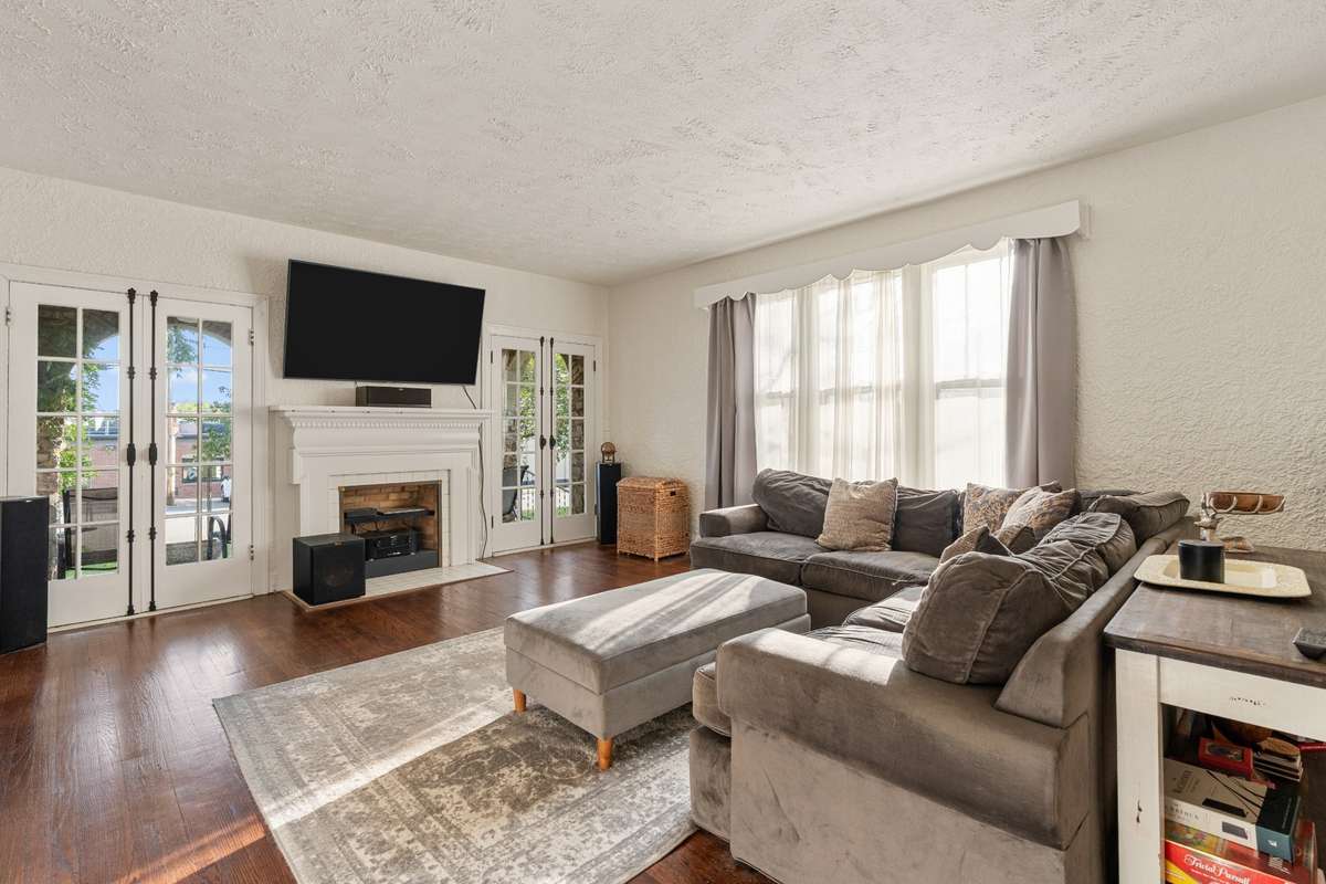 French doors on either side of the fireplace lead to the stone side porch.