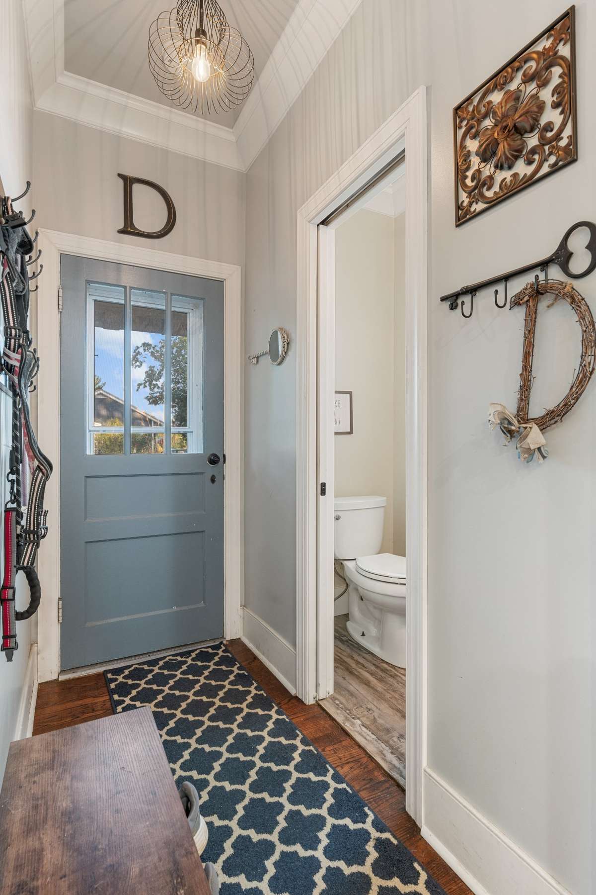 Entry way from the back door and half bath.