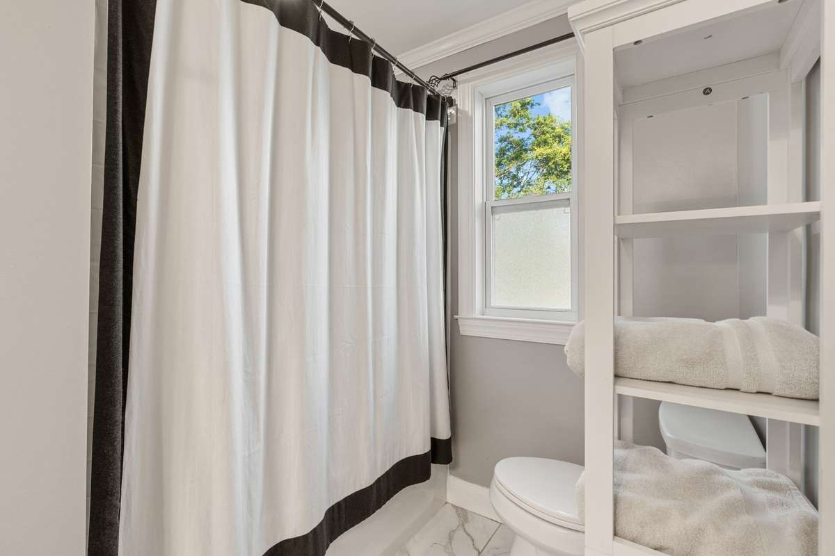 Tub shower combo in second bathroom upstairs.