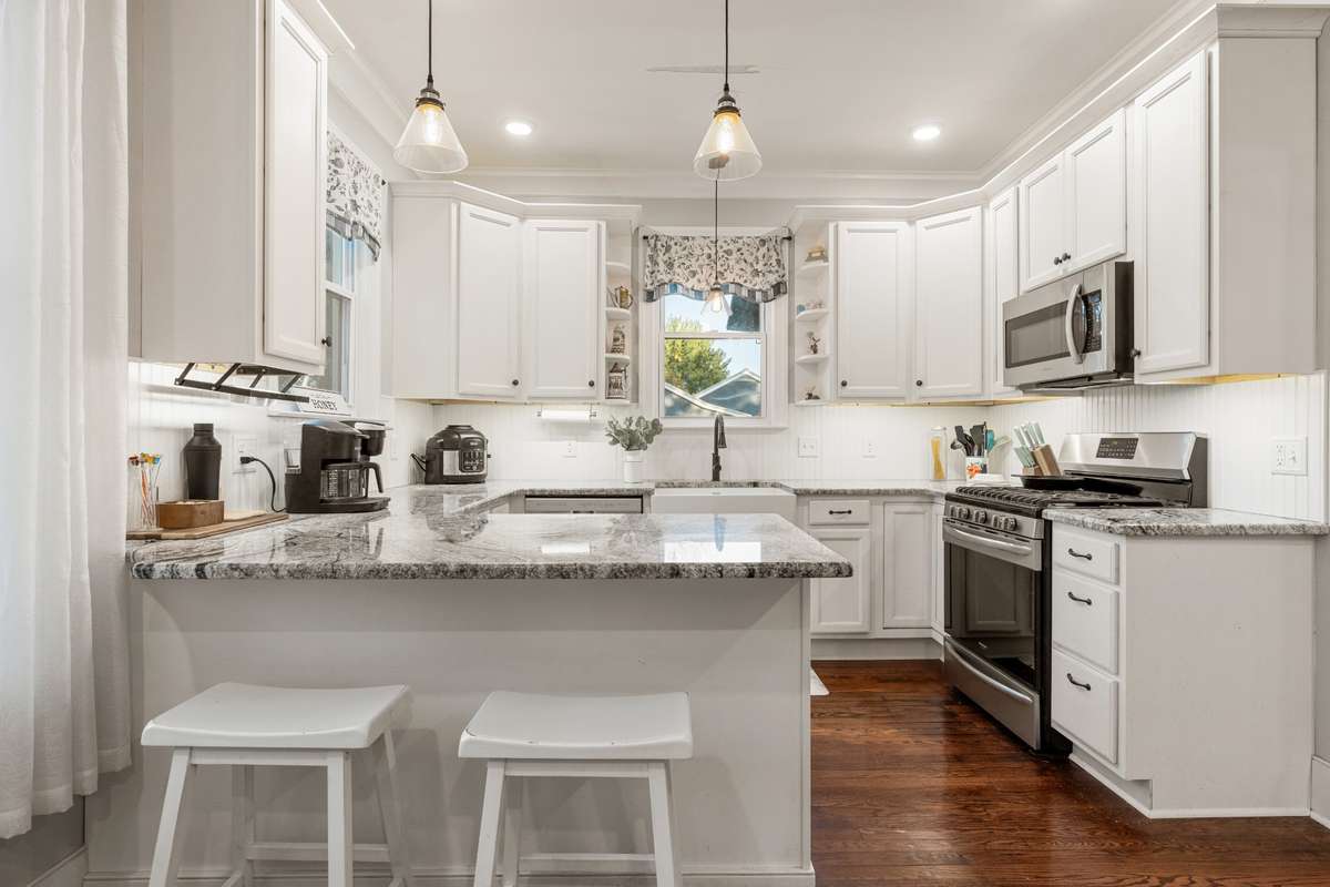 Beautiful modern farmhouse kitchen with newer cabinets and granite counters.