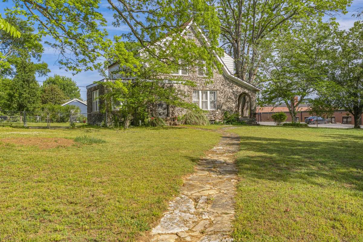 A cute stone pathway leads in from the front yard up to the front door.