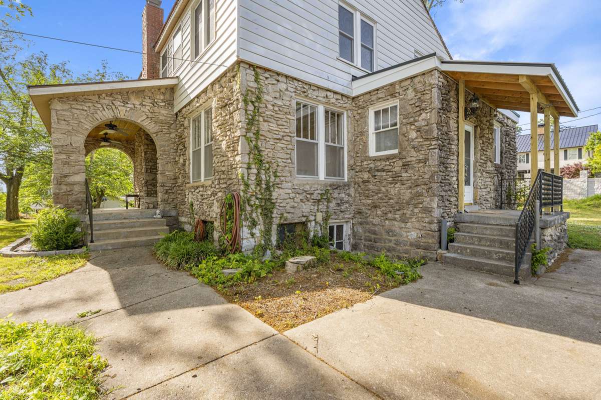 The doorway to the left off the small porch leads into the entryway and kitchen. With the location near the driveway it is the perfect entrance to the home for daily living.