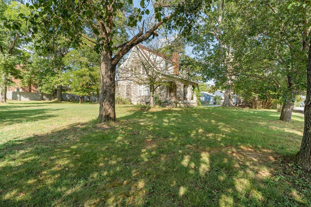 Mature trees scattered through the yard provide shade and privacy.