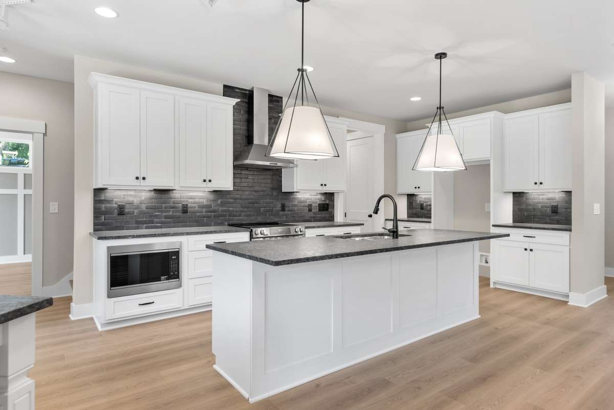 All the appliances are stainless, the lighting is stellar and the black finish fixtures are a hit!