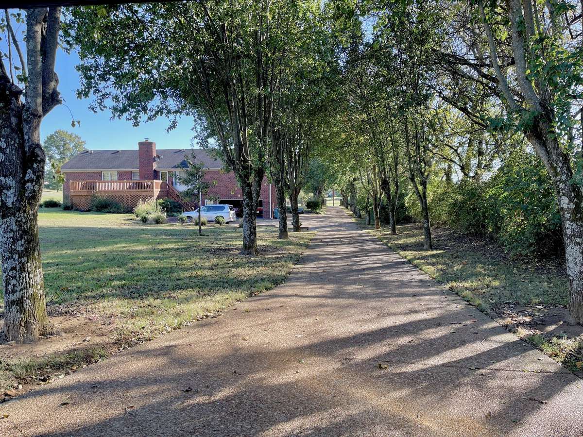 Set back from the road, the long, sweeping driveway offers exceptional privacy and ample parking for gatherings.
