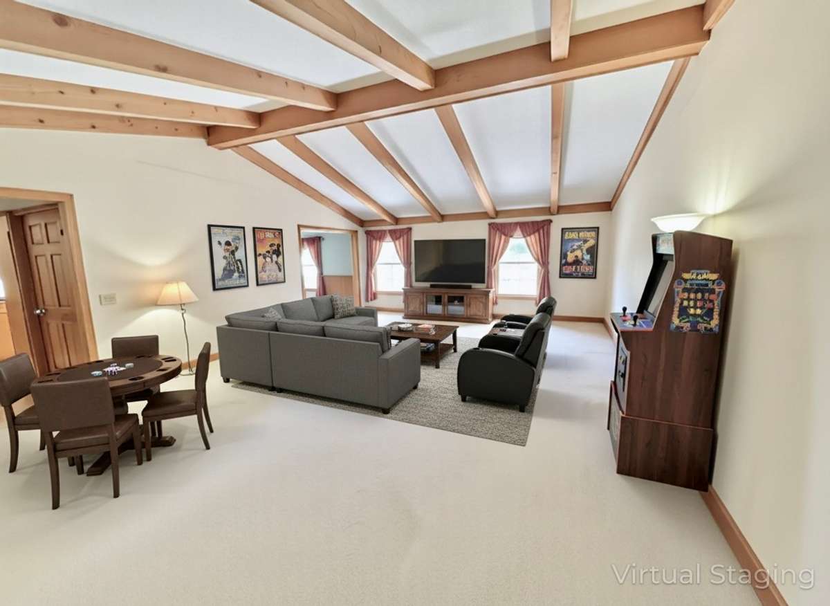 Perfect for large gatherings, this oversized great room features a vaulted ceiling, creating an open and inviting space for family and friends. Virtually Staged Photo for Inspiration Only and to Showcase How Space Can Be Used and Furnished.