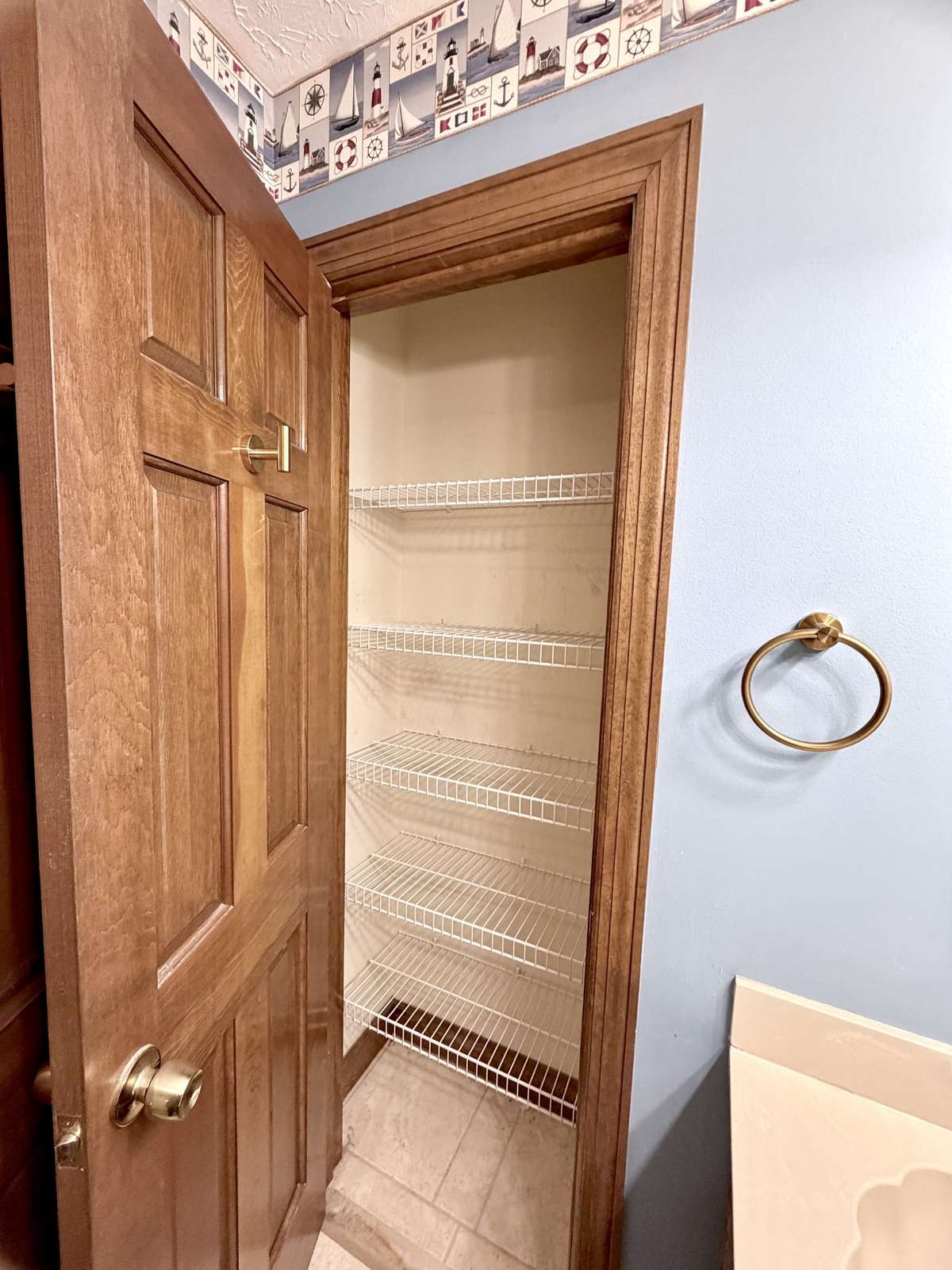 Guest bathroom has linen storage.