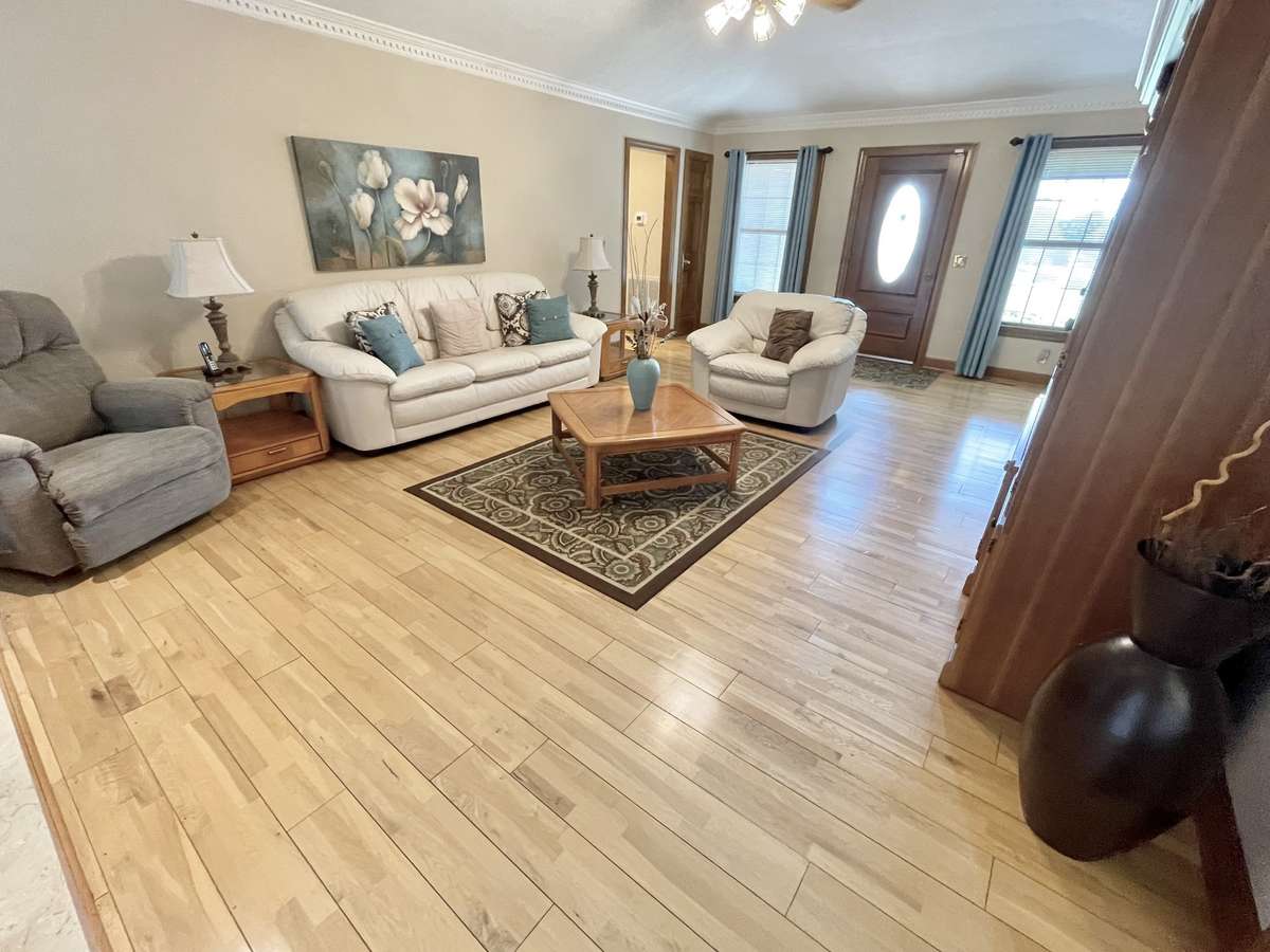 Separate living room with fireplace offers a cozy spot for quieter moments.