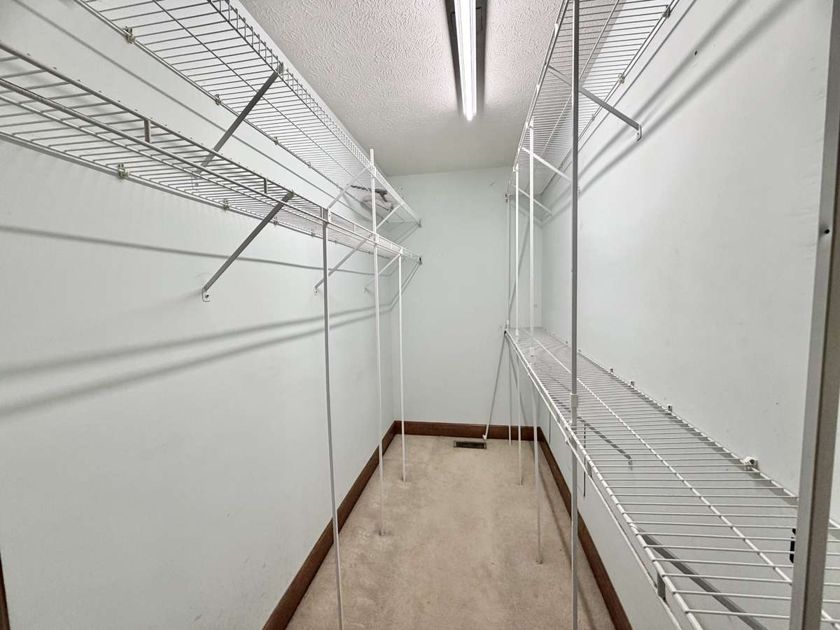 Primary bedroom features a generous walk-in closet, providing ample space for wardrobe organization and storage.