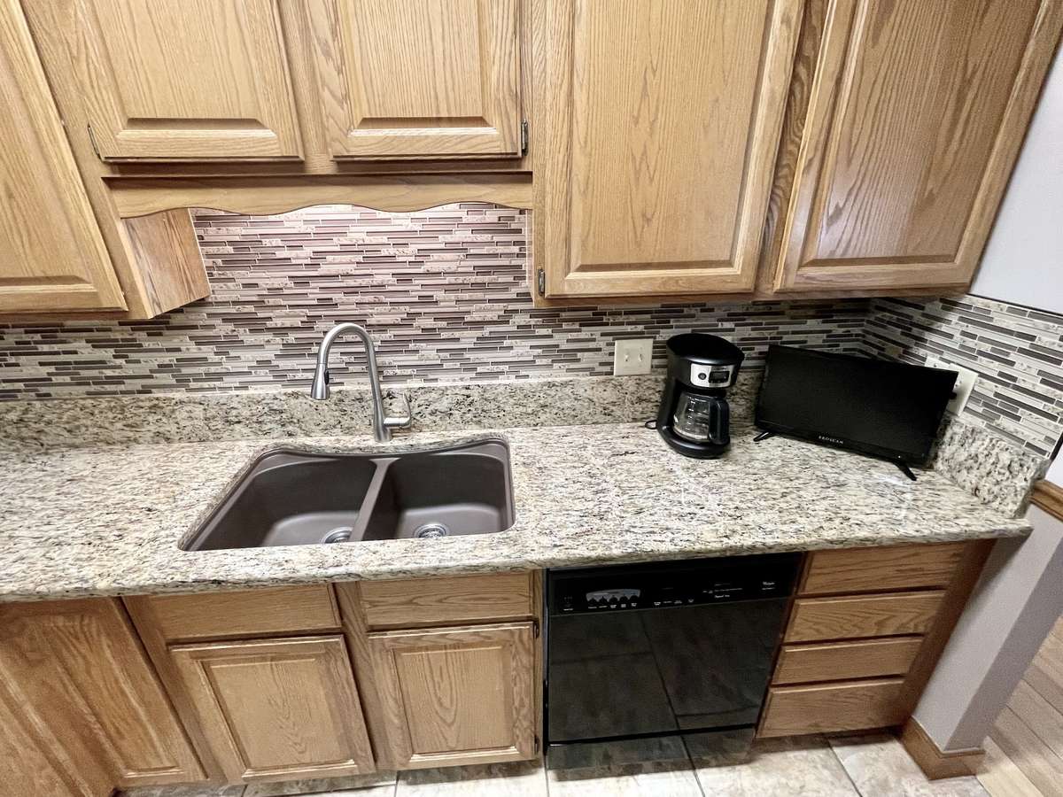 Double under-mount composite sink with stylish pullout faucet.