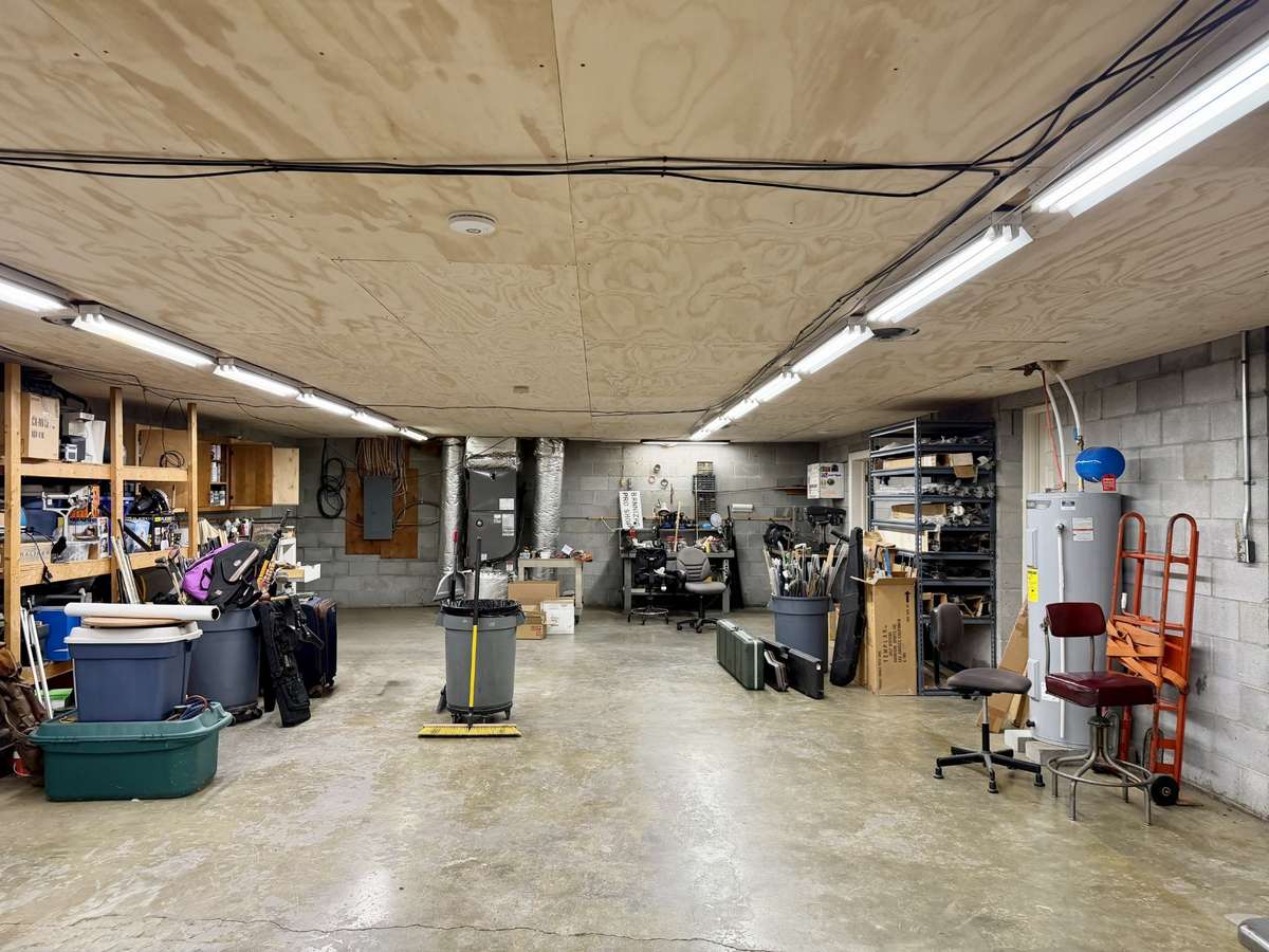 Approximately 1,300 sq. ft. of conditioned storage or expansion space in basement—perfect for a WORKSHOP, HOME GYM, or future finished area. Basement also includes finished office and full bath with shower.