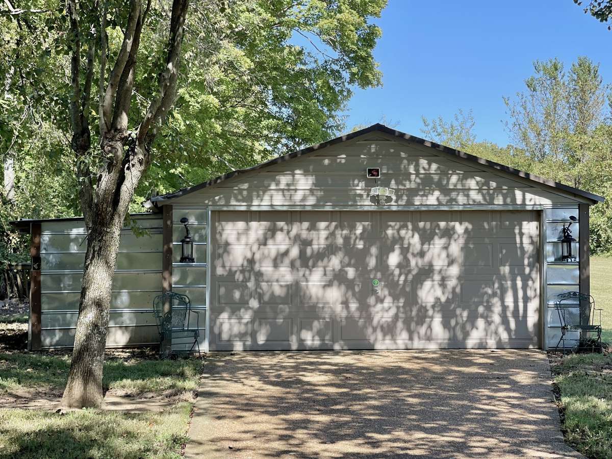 An additional metal storage building adds even more versatility—ideal as a detached 2-car garage, workshop, or space for lawn equipment, tools, or recreational gear.
