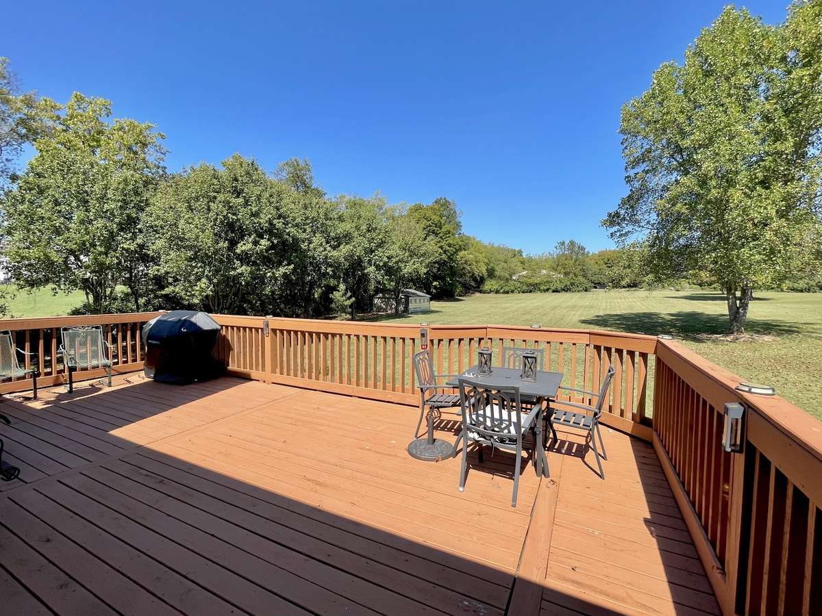 Enjoy plenty of elbow room on this expansive, level parcel of land, and breaking bread on your spacious back deck, taking in serene views of the expansive and spectacular backyard.