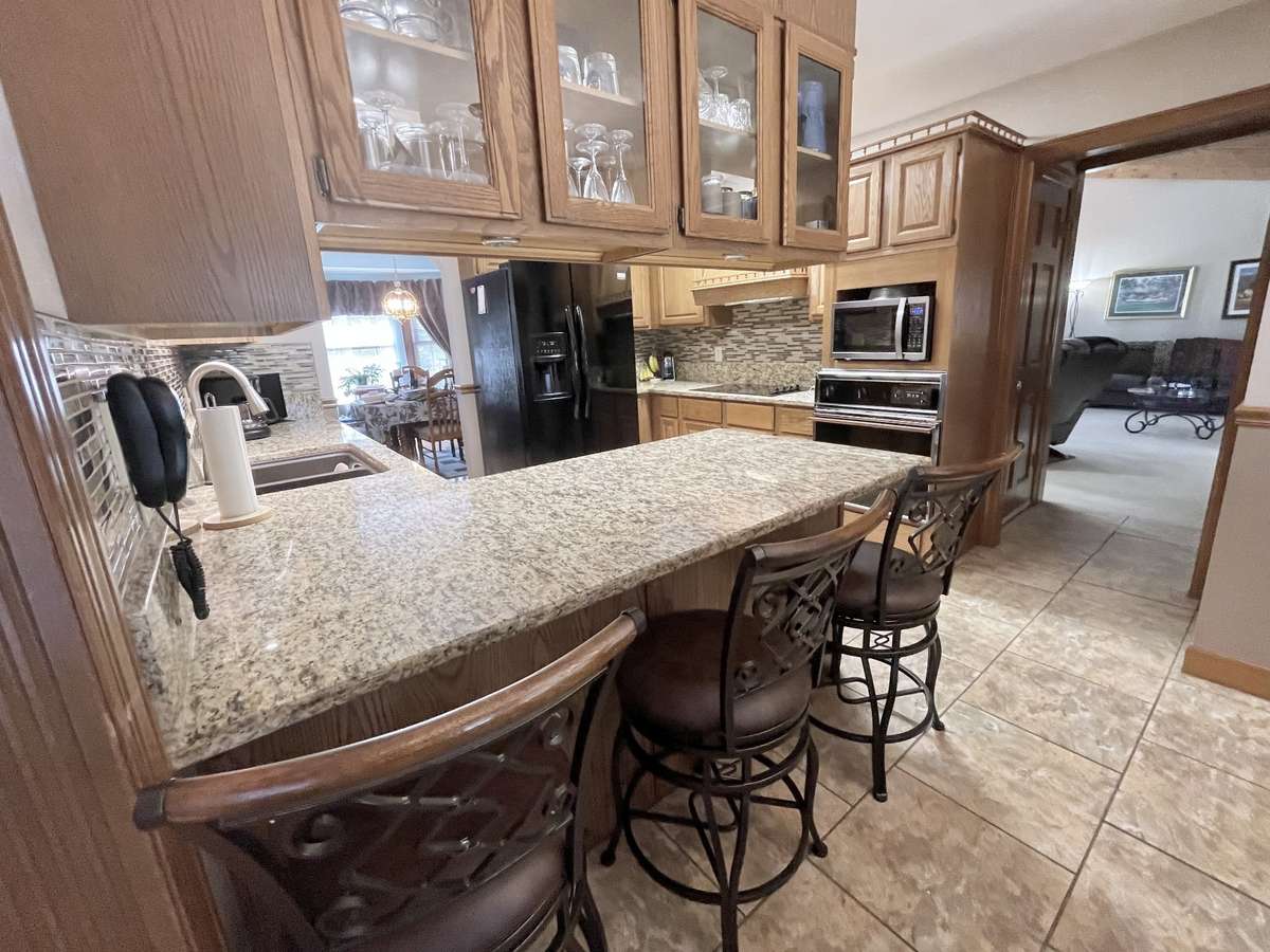 Kitchen is centrally located between great room and living room and adjacent to dining room, providing a perfect flow for large gatherings and entertaining.