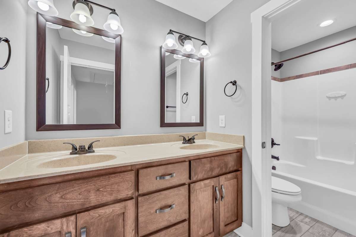 Upstairs hall bath with 2 vanity sinks and a separate tub/toilet area