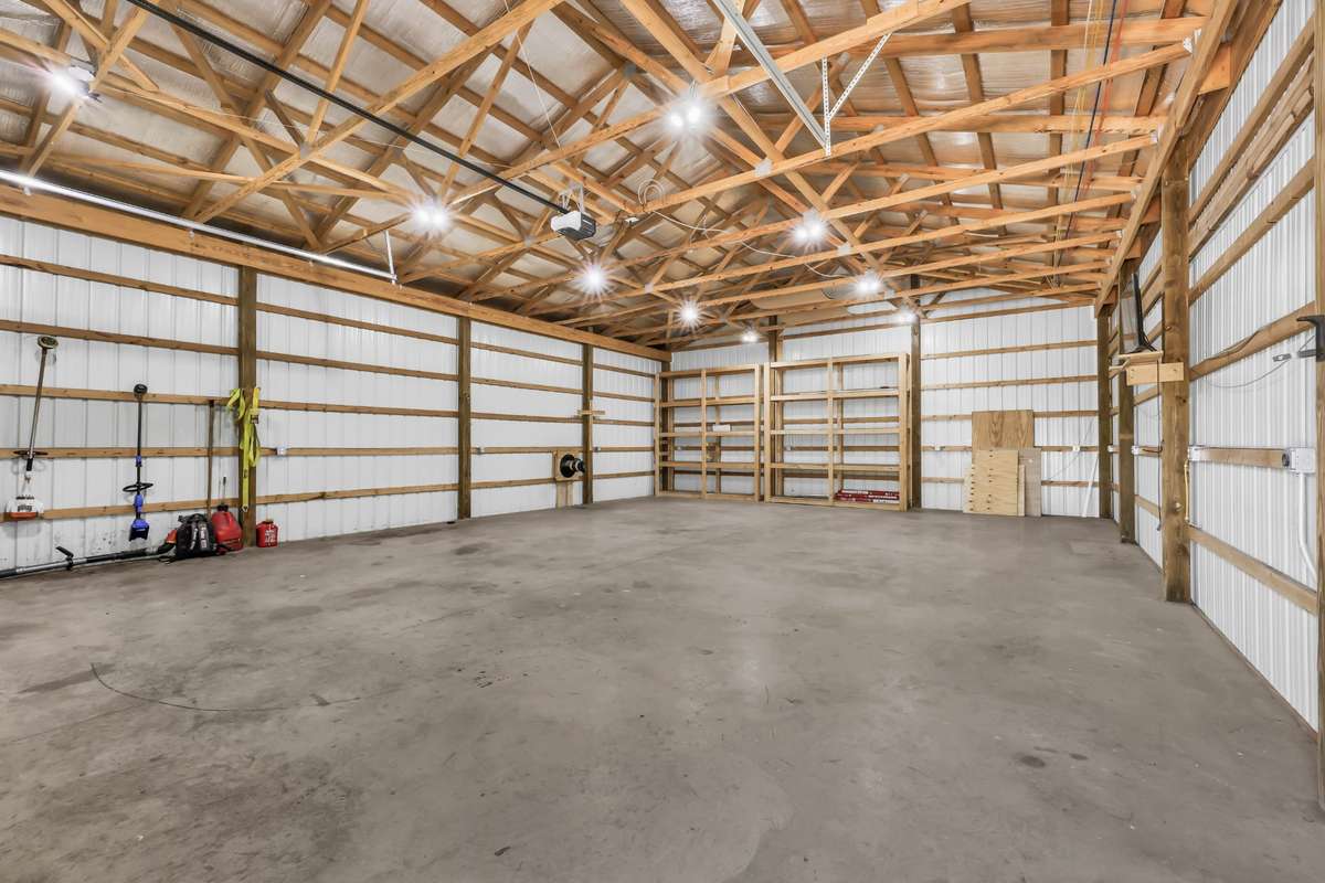 Workshop/garage is equipped with 220 outlets, a flue for a wood stove, WiFi, and a tall ceiling.