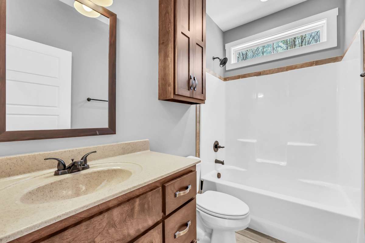 Full-size guest bath, with over-the-toilet storage cabinet