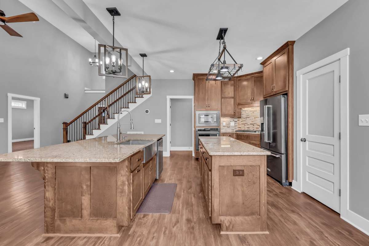 Lots of cabinets, granite counters, and stainless steel appliances.