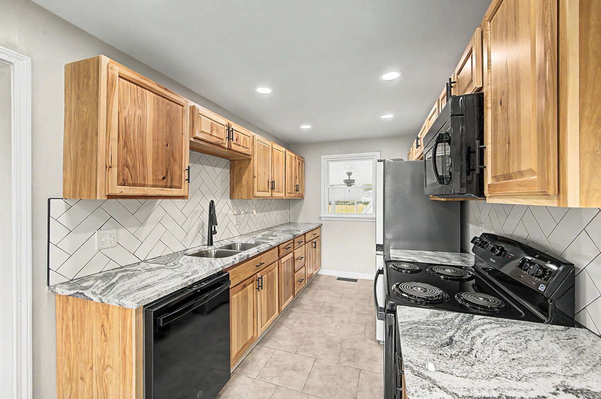 The beautiful granite counter tops and custom backsplash just enhance the beauty of this kitchen