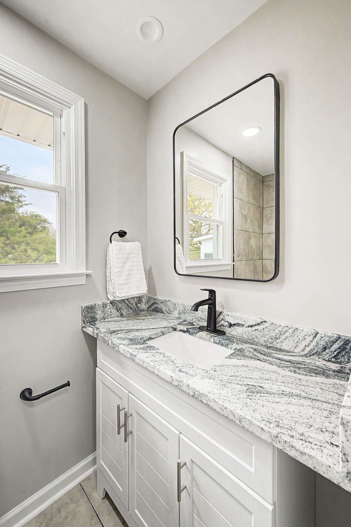 Second new bathroom complete with new tile floors, new vanity, new sink, new mirror and new mirror