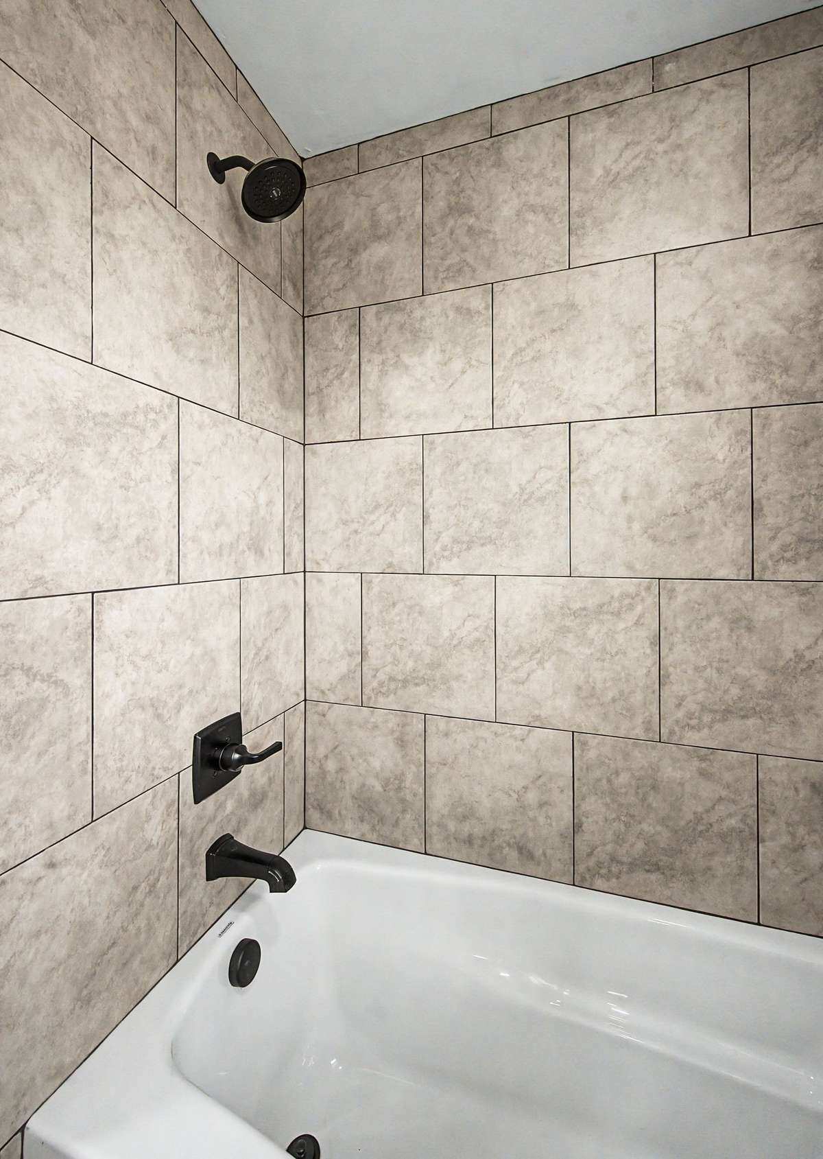 This bathroom has a gorgeous tiled shower/tub combo.
