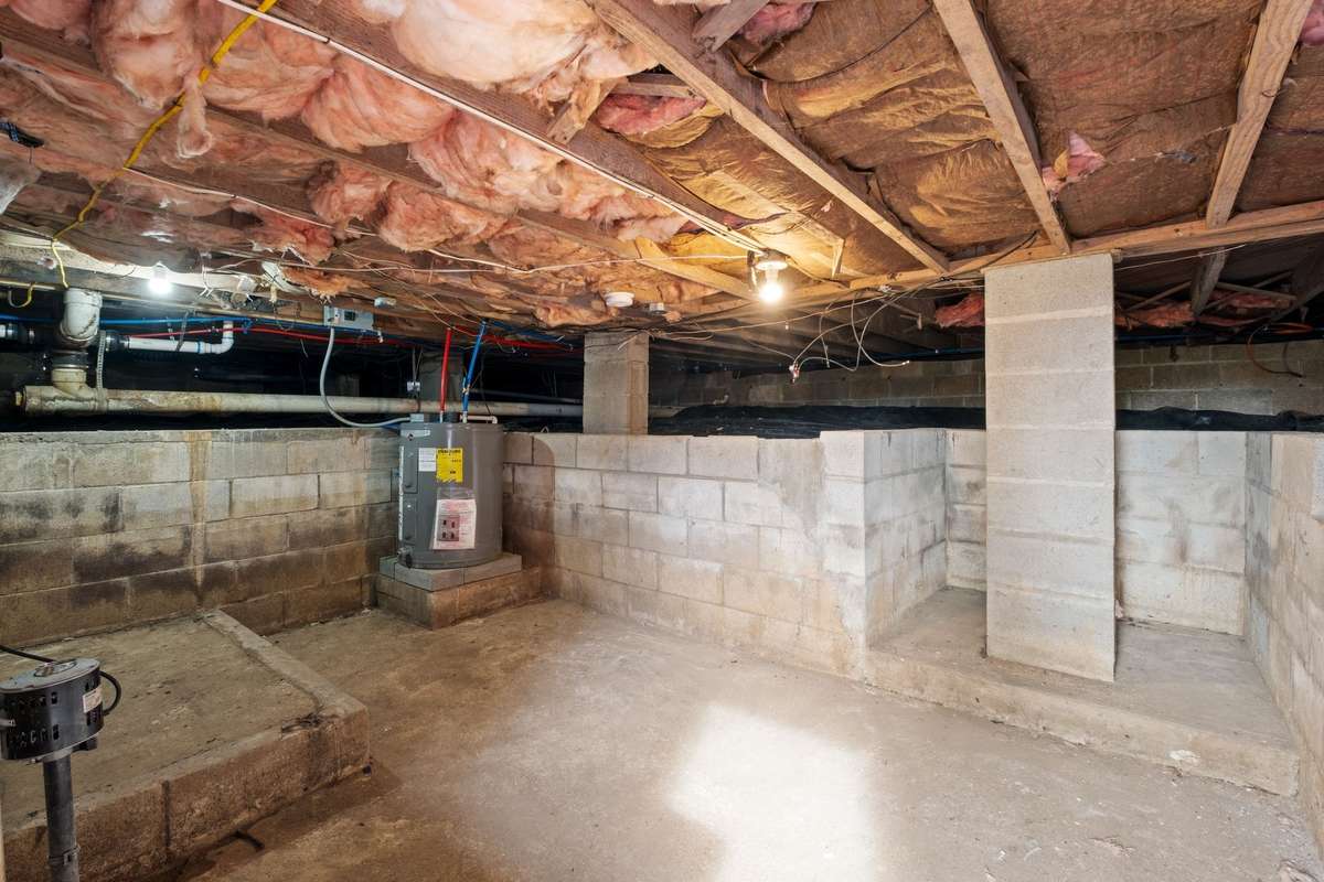 Crawl space is awesome for storage or small workshop!   Water heater is located here! There is a working sump pump -so no worries about flooding!