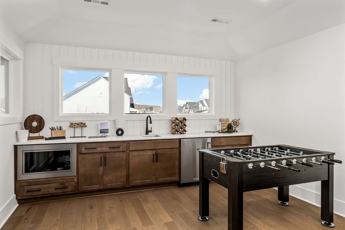 Large bar space with sink, counter refrigerator and microwave. No need to travel downstairs for popcorn, queso and drinks when either entertaining, Game nights or relaxing with a good movie in the Media room.
