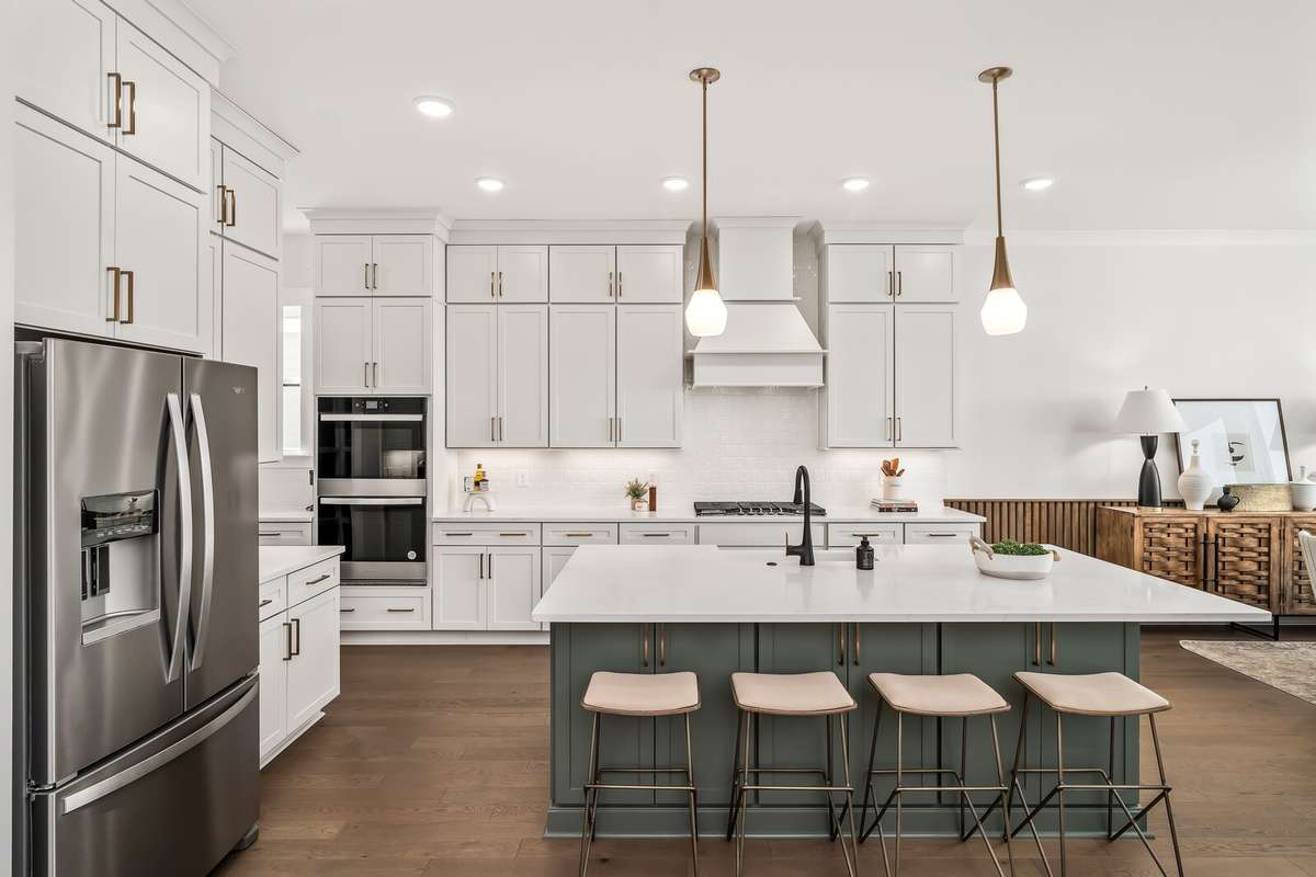 Kitchen cabinets meet the high 10 foot ceilings offering a plentiful amount of storage.