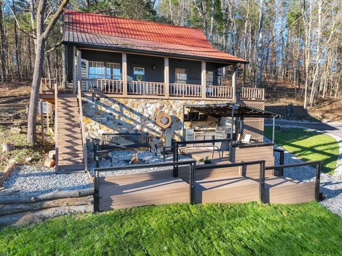 Enjoy the wraparound covered porch or walk down the stairs to enjoy the outdoor kitchen, firepit, and hot tub!