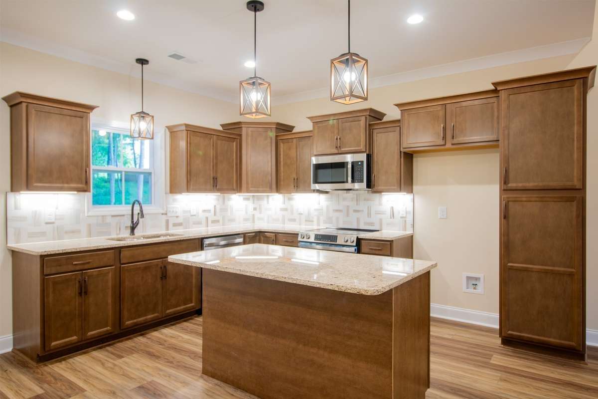 EXAMPLE>>>Kitchen with Under Cabinet Lighting, Granite Countertops, Island with Bar Top, Stainless Steel Appliances, Lots of Cabinet and Counter Space and a Cabinet Pantry!