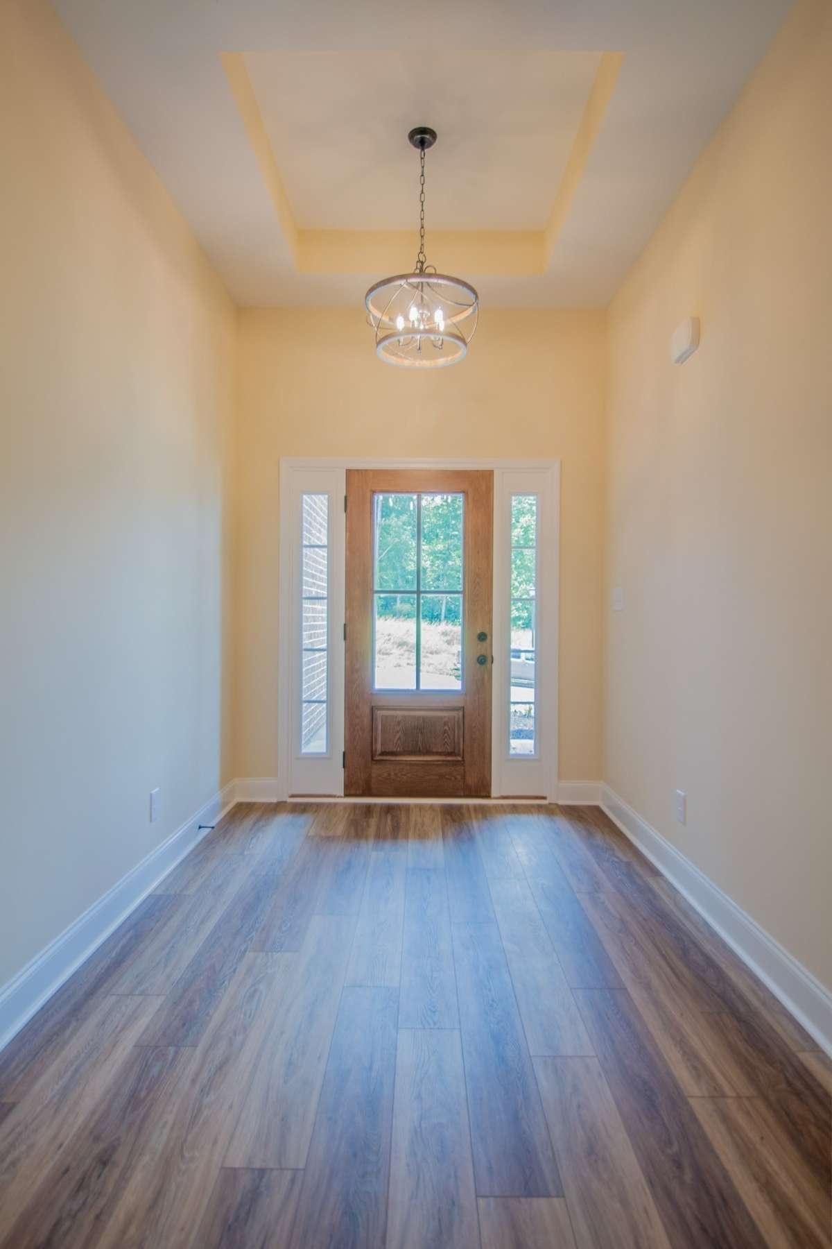 EXAMPLE>>>Spacious Entry Foyer with a Gorgeous Front Door and an Elegant Chandelier! LVP Flooring Welcomes You In and Continues Throughout the Foyer, Living Room, Kitchen, Dining Room, and Hallways!