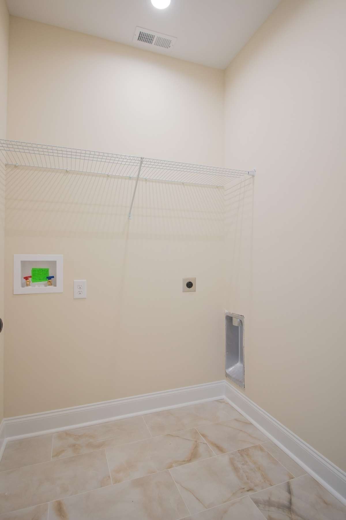 EXAMPLE>>>Spacious Laundry Room with Tile Flooring and Shelving!