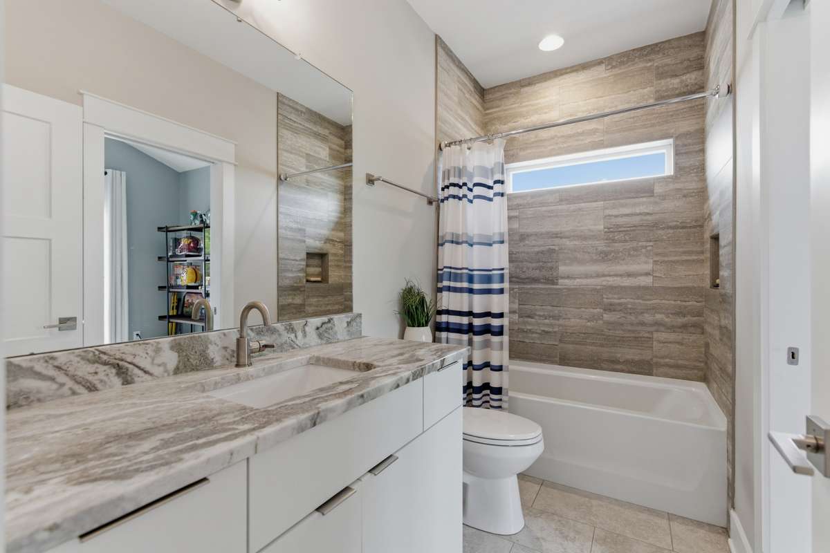 The attached bathroom can also be accessed from the hall. The wide vanity offers convenient storage underneath.