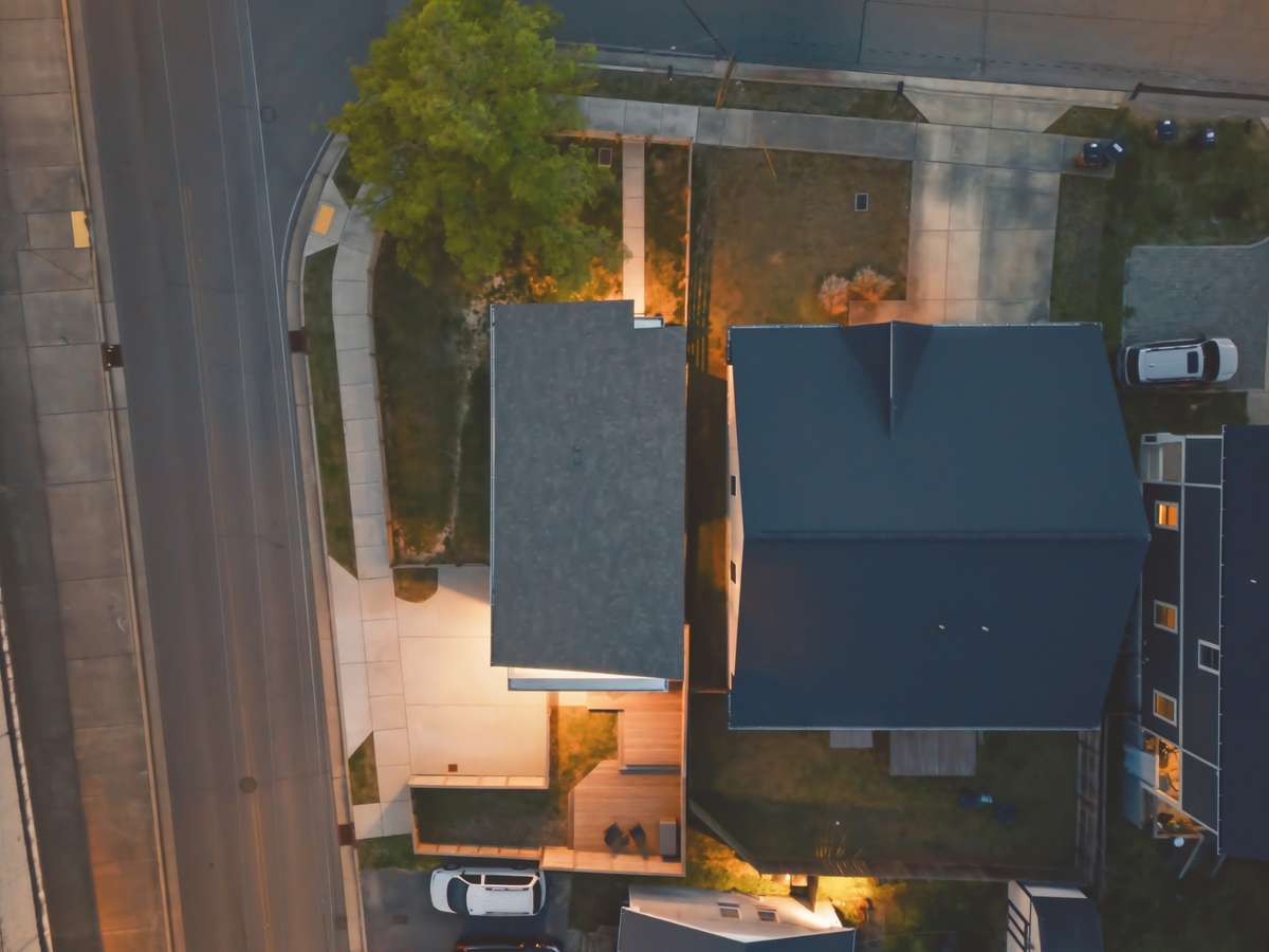 A quiet cul-de-sac street frames one side of the corner lot.