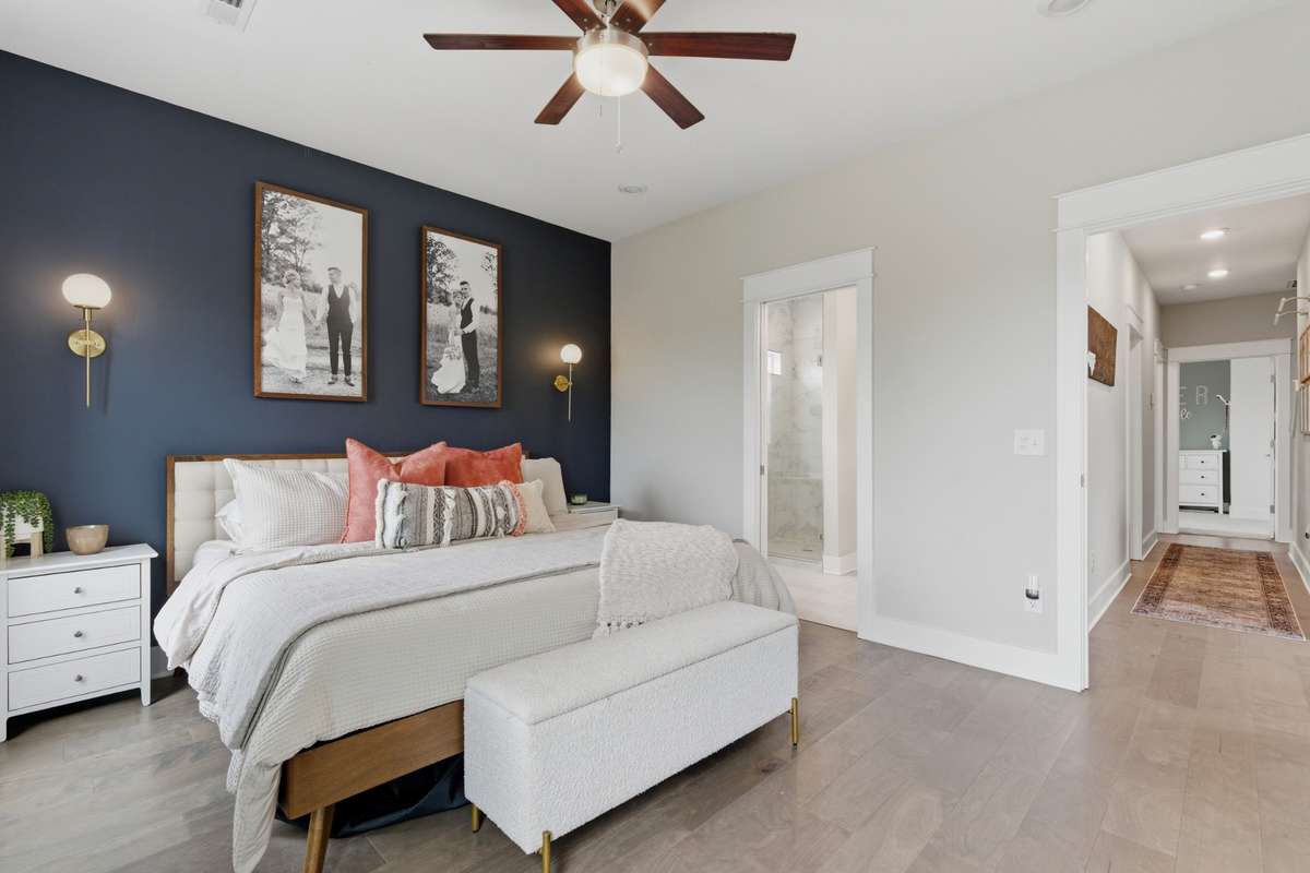 Chic wall sconces highlight a navy accent wall.