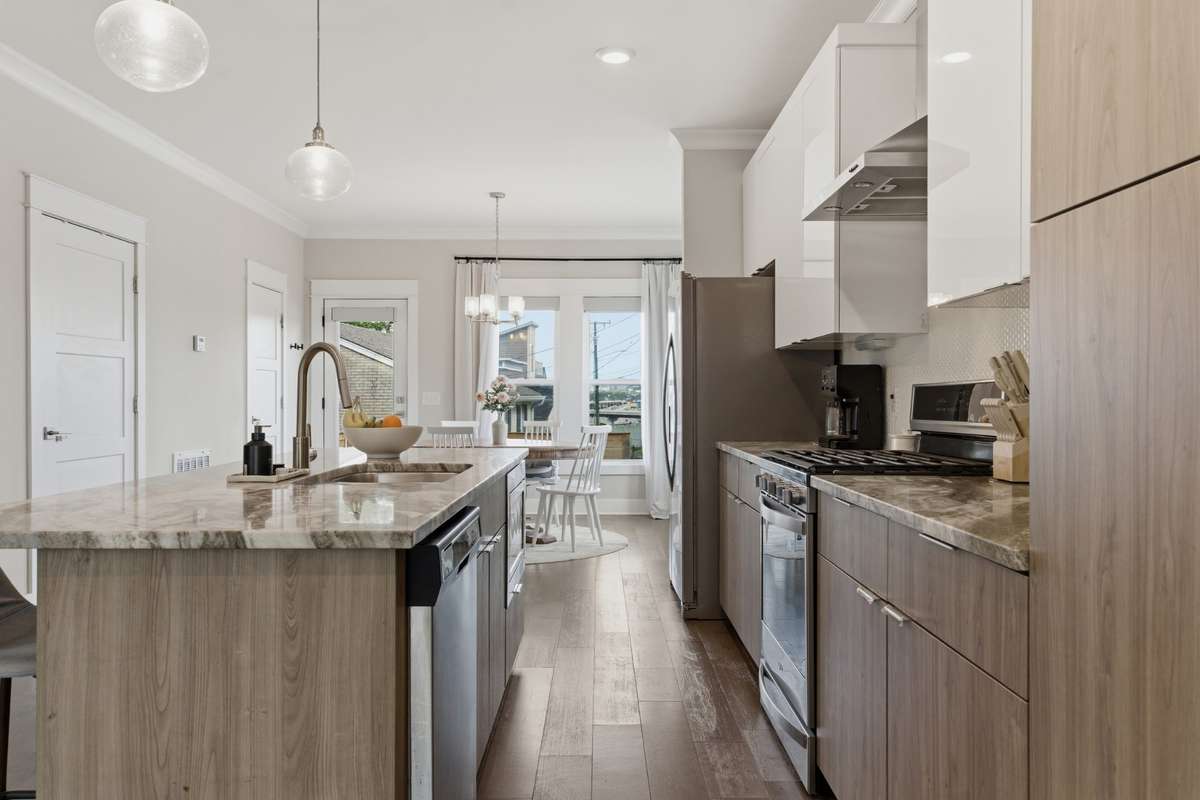 The stainless steel appliances include a sleek gas range.