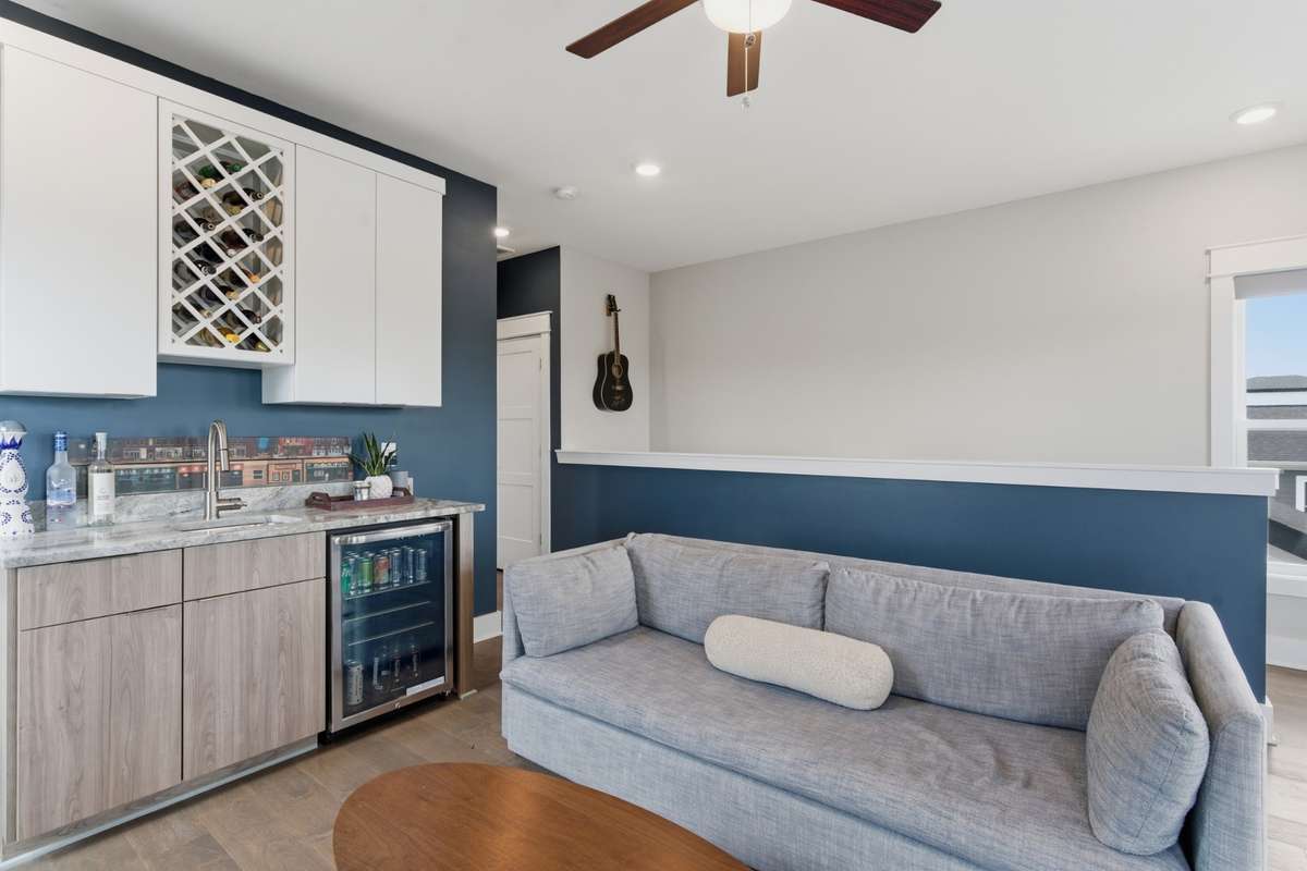 It even has a wet bar with custom cabinetry and a beverage fridge.