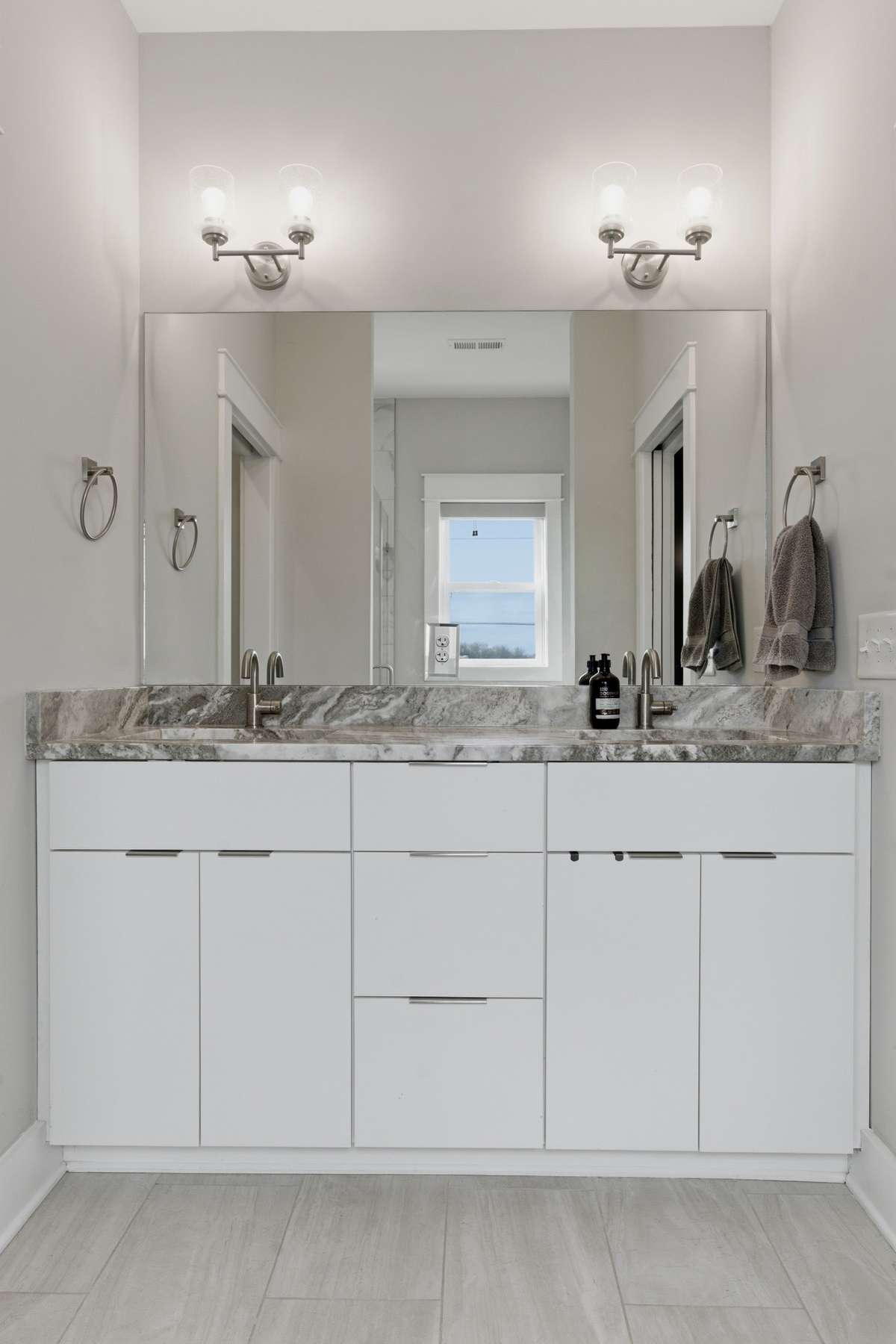 The primary bath features a built-in granite vanity with an extra wide mirror that makes getting ready easy!