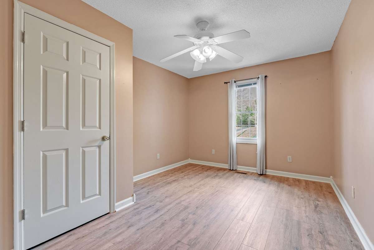 Spacious third bedroom with large closet, neutral color scheme & ceiling fan. 645 Wildwood Trace, Winchester, TN 37398