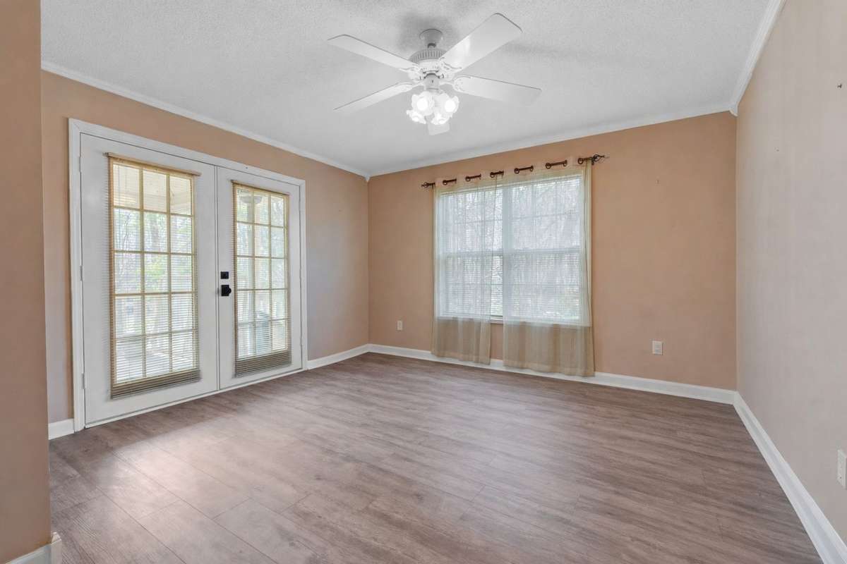 Primary suite with crown molding, double window & French doors providing private access to the covered deck. 645 Wildwood Trace, Winchester, TN 37398